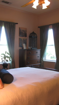 corner of room, windows, dresser, overhead fan