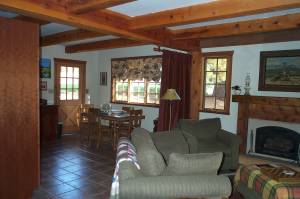 main room in cottage viewing into kitchen area