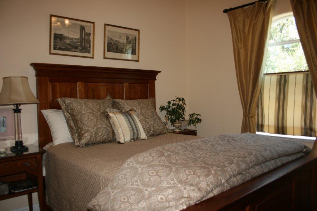 traditional queen bed and dresser, large windows, shower